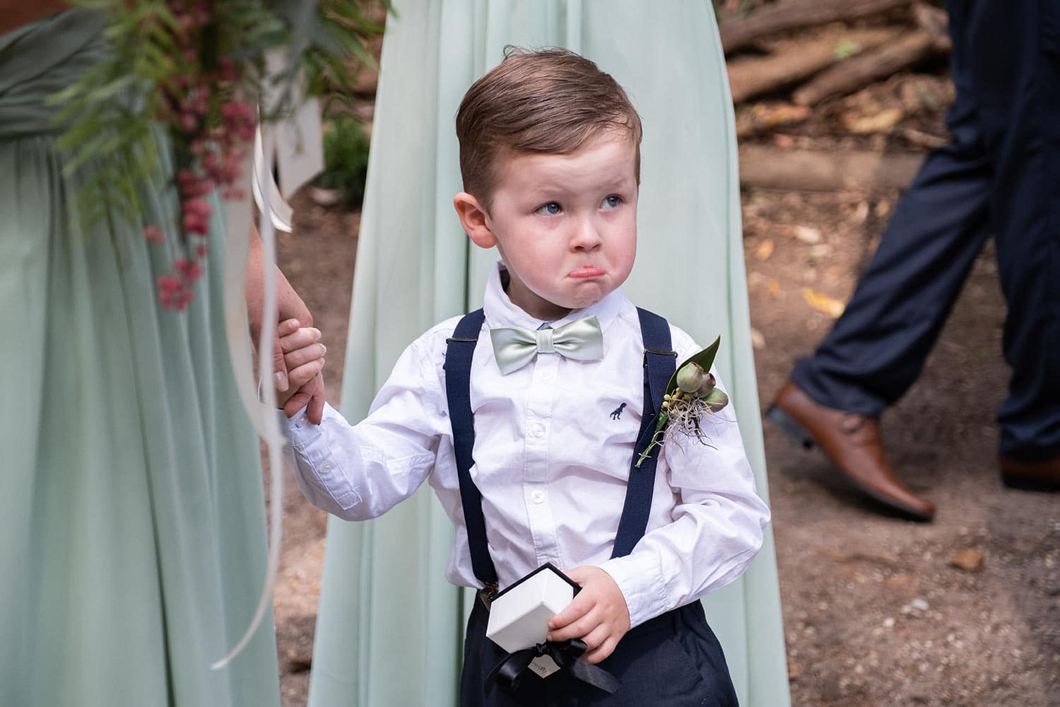 young boy at wedding looking sad