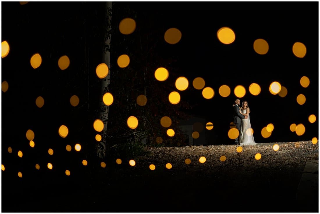 fairy lights night time wedding photo with bride and groom