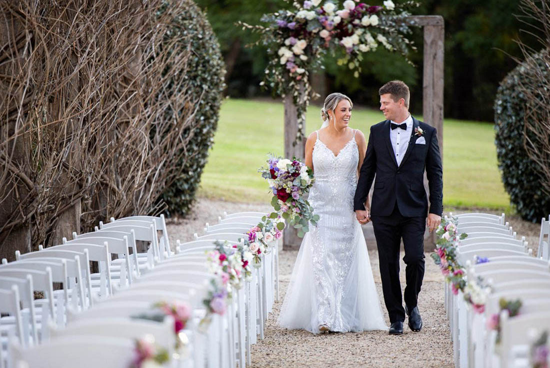 central coast wedding photographer bride and groom Fernbank Farm bride and groom walking back up the aisle at Fernbank Farm in winter time